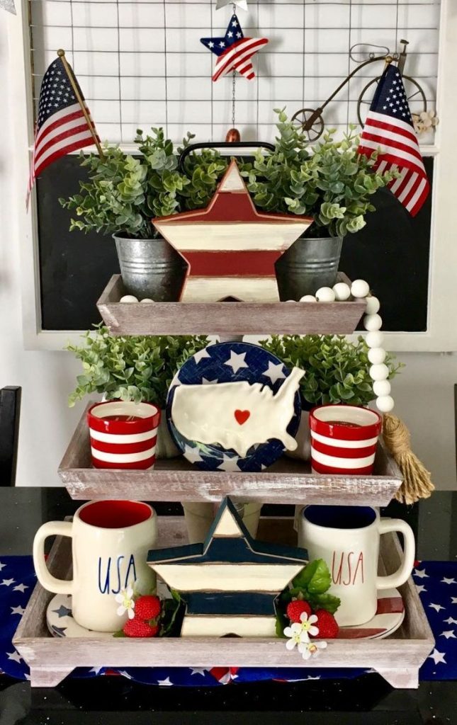 Festive red, white, and blue tray with USA mugs, striped stars, faux strawberries, and patriotic greenery.