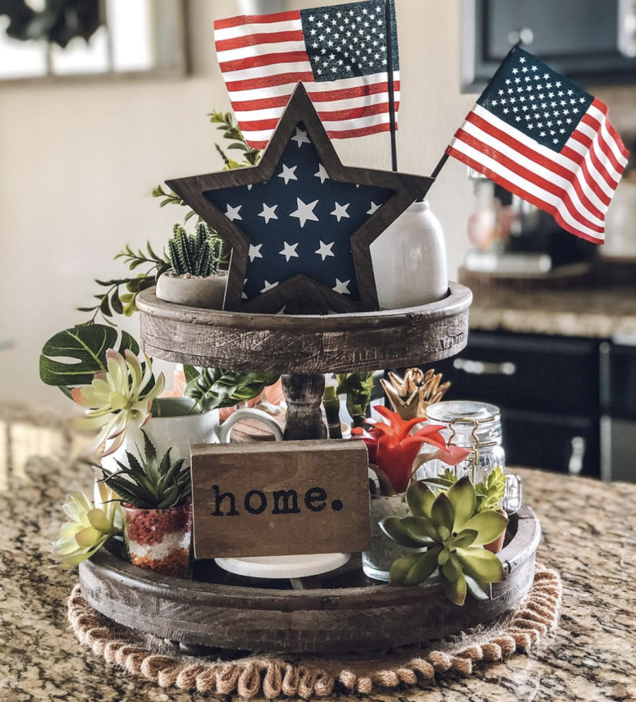 Rustic wood tray with large blue star, mini American flags, faux succulents, and a 'home.' sign centrepiece.