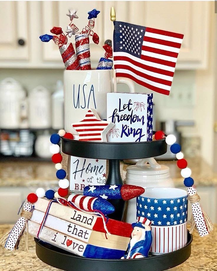 Bright and glittery firecracker-themed tray with a USA mug, 'Let Freedom Ring' sign, and red, white, and blue garland.