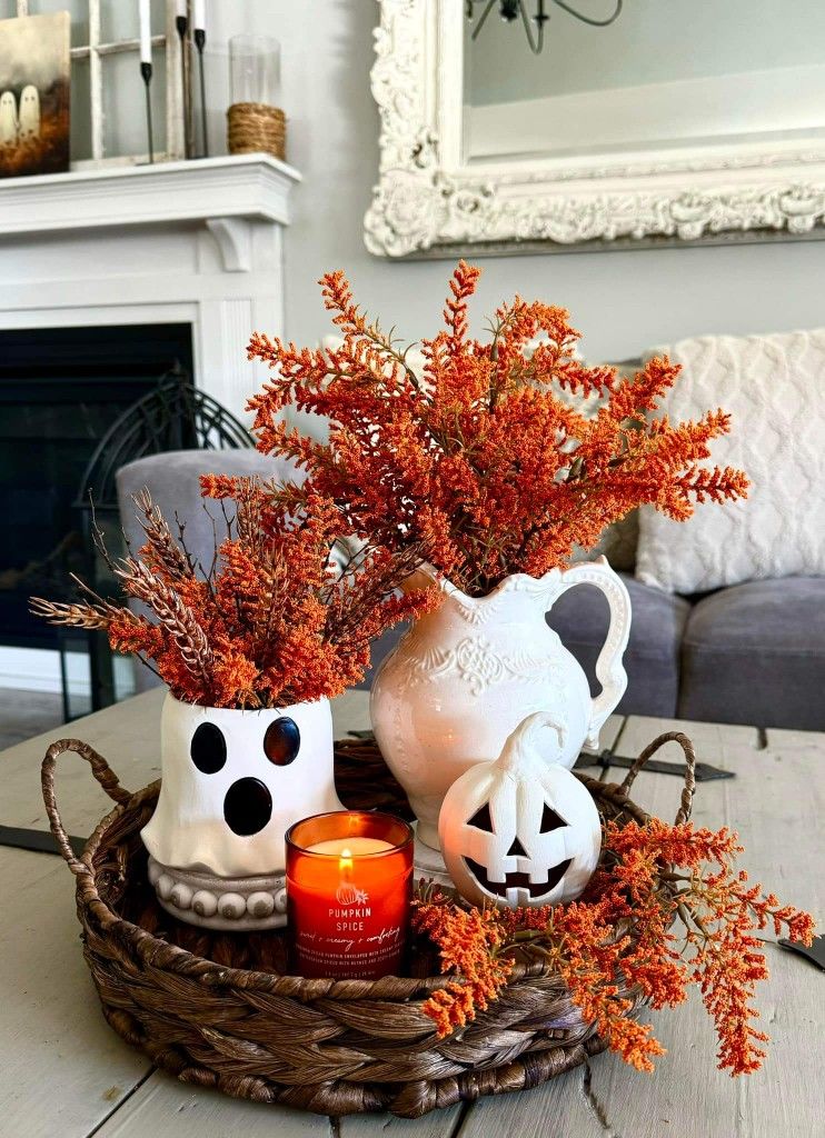 Woven tray with ghost vase, white pitcher, orange autumn stems, pumpkin spice candle and jack-o’-lantern figurine