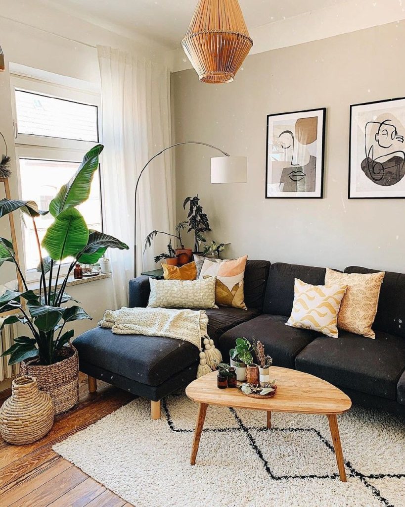 Two large black framed abstract line art prints side by side above a dark sofa.
