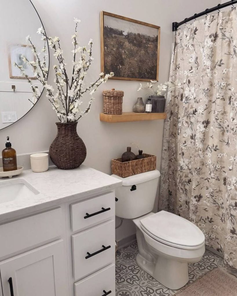 Bohemian chic bathroom with woven textures, floral shower curtain, and a large woven basket for storage on the toilet cistern.