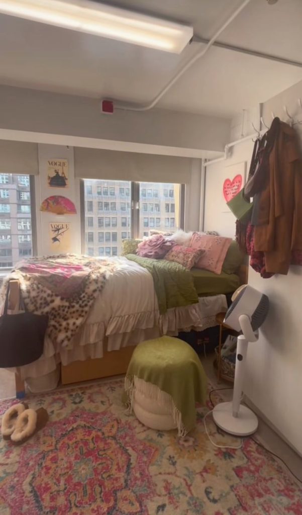 Dorm room with ruffled floral bedding and a colorful medallion area rug