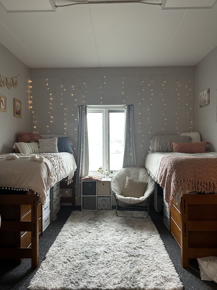 Shared dorm room with string lights across the back wall and a plush rug runner