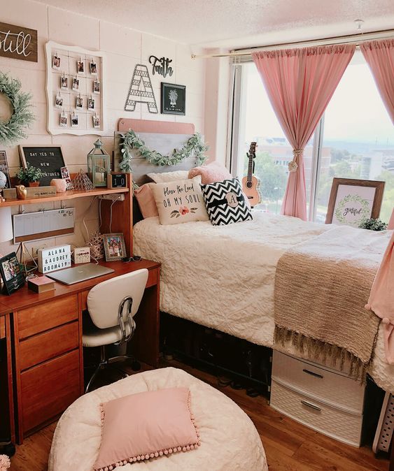 Pink dorm room with hot pink curtains, blush bedding, and a personalized desk setup