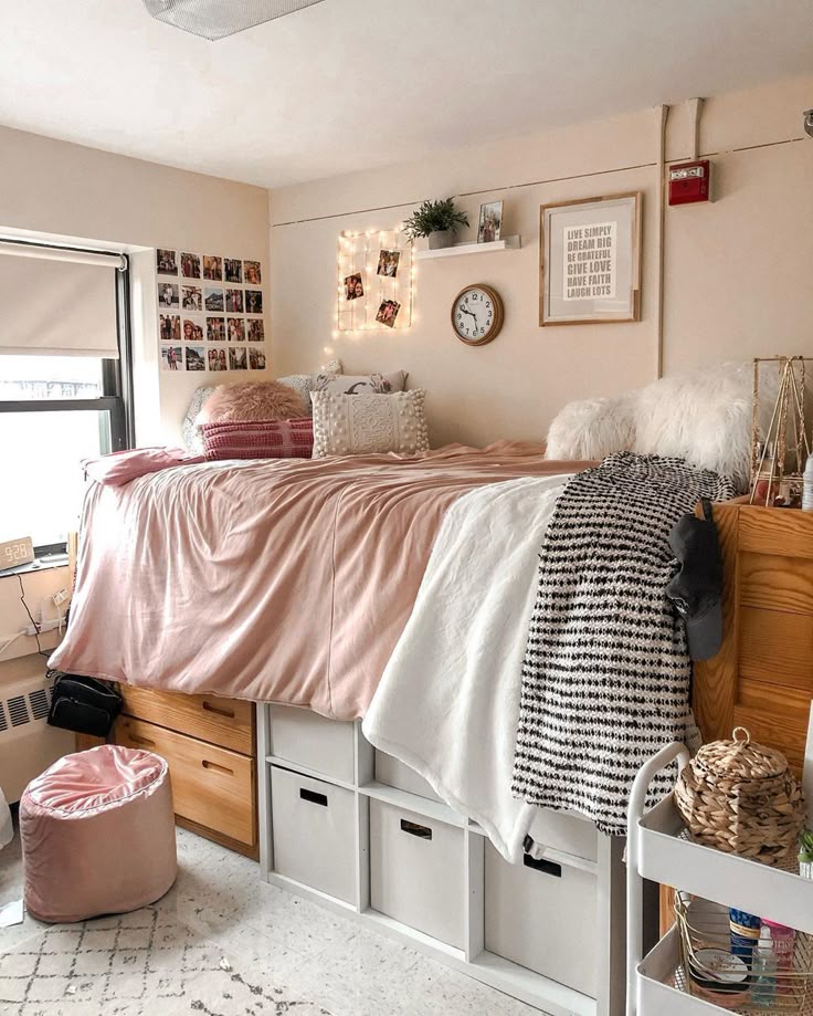 Pink dorm room with a photo clip string above the bed and a small floating shelf
