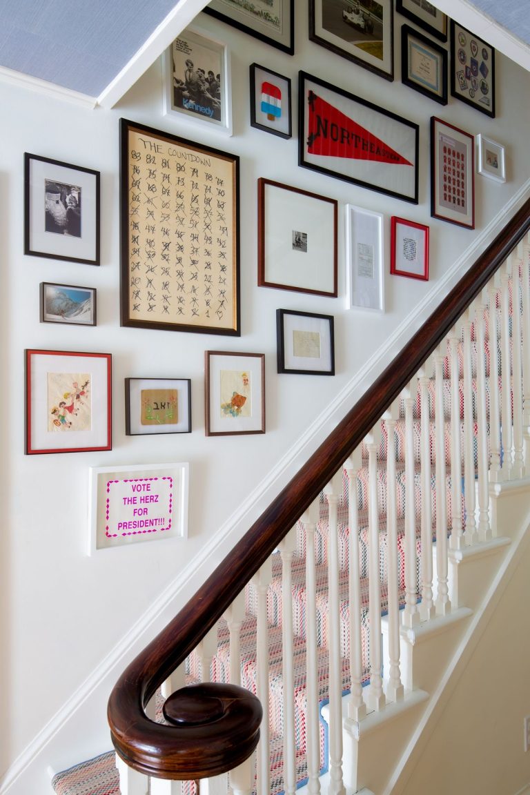Gallery wall of sentimental keepsakes and framed memorabilia on staircase