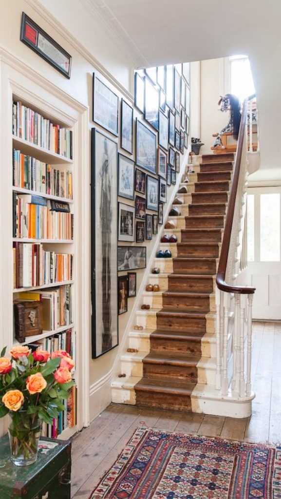 Tall narrow gallery wall running the length of a staircase