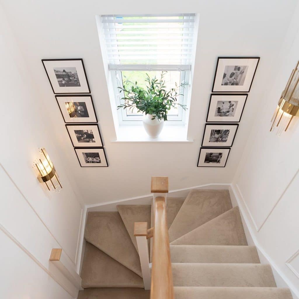 Black and white photo columns framing a staircase window