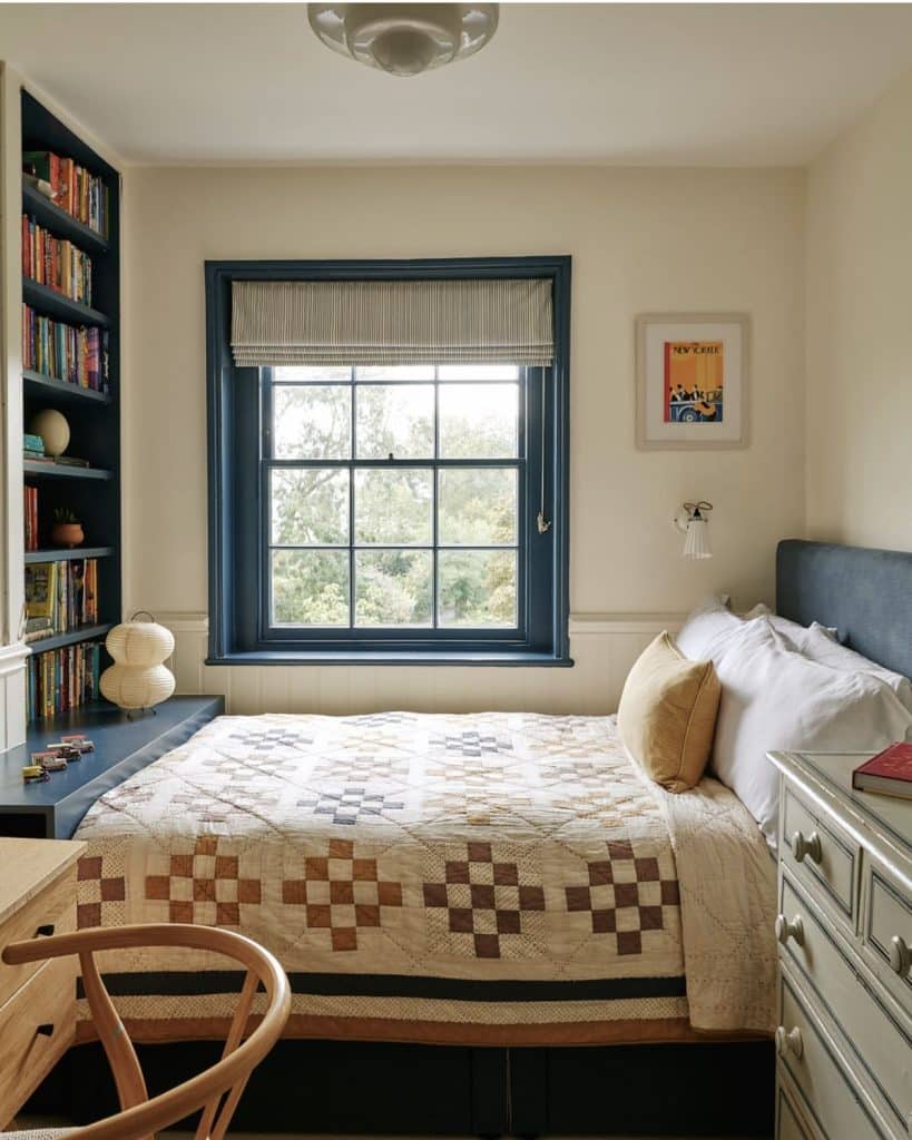 Kids bedroom with built in bookshelf beside a window nook