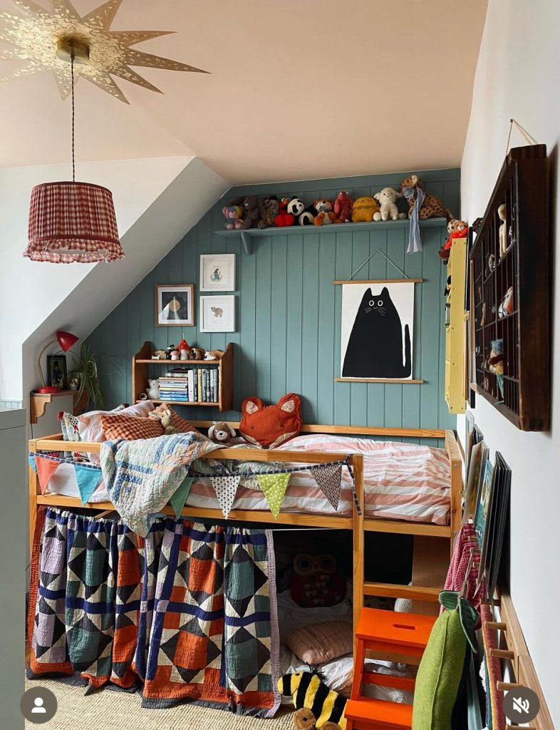 Attic kids bedroom with statement pendant light over bunk beds