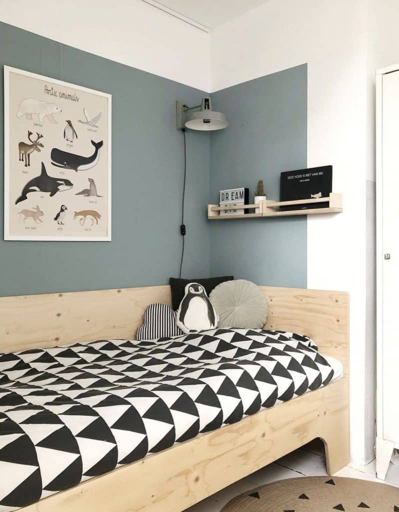 Small kids bedroom corner with Arctic animal poster and graphic bedding