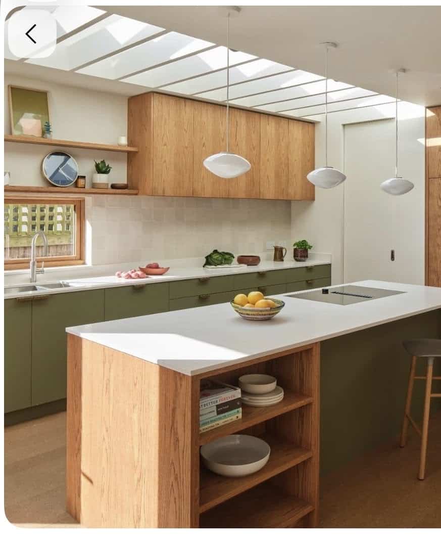 Bright mid century kitchen with olive green base cabinets, warm oak upper cabinets and island, open island shelving, pale quartz benchtops and skylights.